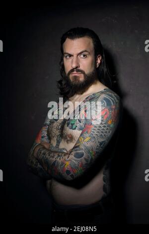 Young handsome masculin man with japanese tattoos Stock Photo