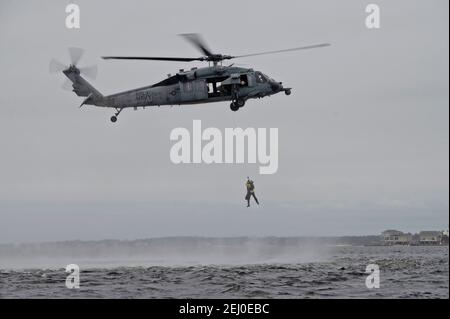 U.S. Air Force Special Tactics teams assigned to the 24th Special Operations Wing, conduct hoist operations with a Navy MH-60 Seahawk helicopter during Emerald Warrior at Hurlburt Field February 18, 2021 in Mary Esther, Florida. Stock Photo
