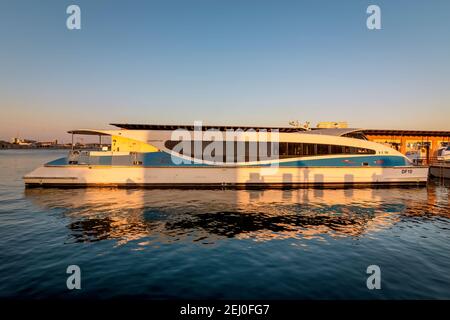 Dubai, UAE, 23 November 2020: Modern ferry of Dubai RTA docked at Dubai creek. Public water transportation connecting several districts like Business. Stock Photo