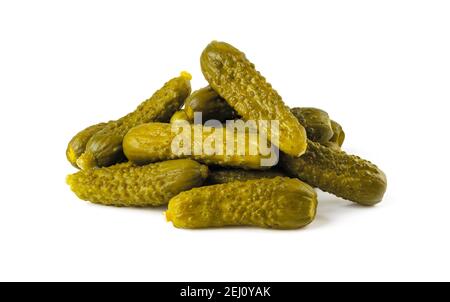 Pile of pickled gherkins isolated on a white background. Whole green cornichons marinated with dill, garlic and mustard seeds. Crunchy baby pickles. Stock Photo