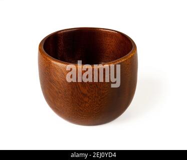 Brown wooden bowl isolated on white background. Eco-friendly tableware made of natural wood. Empty dishes for food design. Living green lifestyle. Stock Photo