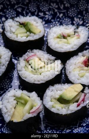 A plate holding portions of home made vegetarian sushi Stock Photo