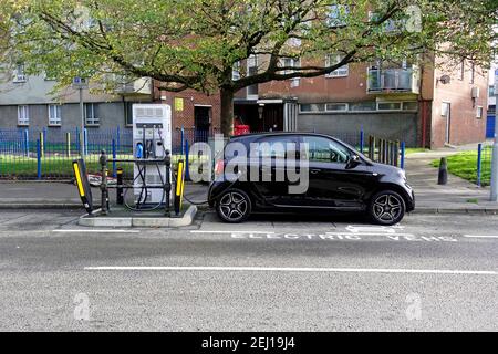 Poole, Dorset / UK - November 3 2020: An all electric Smart ForFour plug-in car at an electric car charging point in Old Street Stock Photo