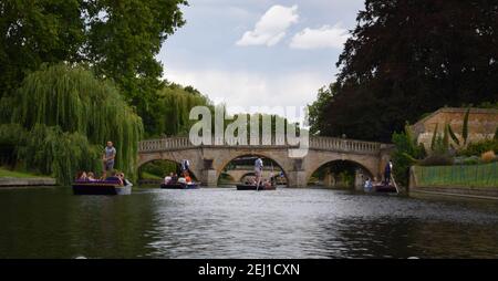 Several punts sail down the river Cam during the summer, Cambridge, England Stock Photo