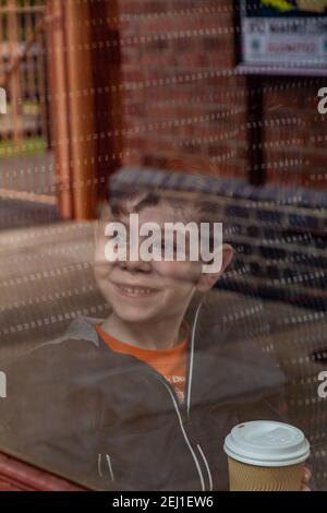 Boy looking through a train's window Stock Photo