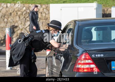 Police stop a woman in a car outside public housing towers on ...