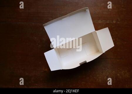 High angle view of empty paper box placed on wooden table Stock Photo