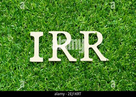 Alphabet letter in word IRR (Abbreviation of internal rate of return) on green grass background Stock Photo