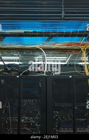 Vertical background image of server cabinet with cables and wires in data center, supercomputer concept, copy space Stock Photo