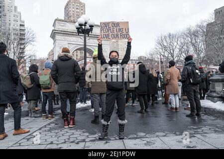 New York, United States. 20th Feb, 2021. More than 200 people gathered on Washington Square Park to rally in support Aisian community, against hate crime and white nationalism. Rally held in New York on February 20, 2021. Rally was organized by ANTIFA (anti-fascist movement) and Abolitionist Community. A woman holds poster with message 'Love Our People Like U Love Our Food'. (Photo by Lev Radin/Sipa USA) Credit: Sipa USA/Alamy Live News Stock Photo