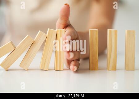 Hand putting and stacking blank wooden cubes on table with copy space for input wording and infographic icon. Stock Photo