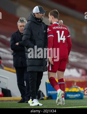 Liverpool. 21st Feb, 2021. Liverpool's captain Jordan Henderson (R) walks past manager Jurgen Klopp after going off injured during the Premier League match (the 238th Merseyside Derby) between Liverpool and Everton at Anfield in Liverpool, Britain, on Feb. 20, 2021. Everton recorded their first win against Liverpool at Anfield since 1999 as they beat Liverpool 2-0. Credit: Xinhua/Alamy Live News Stock Photo