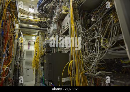 Background image of messy server room with internet cables and wires in heaps, copy space Stock Photo