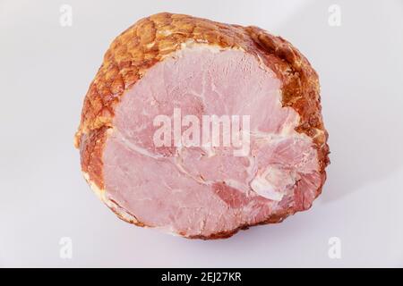 Tasty honey smoked pork ham on white isolated background. Stock Photo