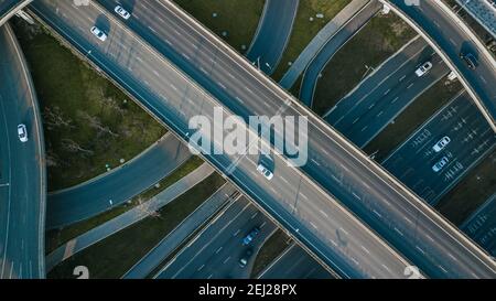 Top up aerial drone view of elevated road and traffic junctions in Chinese metropolis city Chengdu during sunny day. Modern roads construction Stock Photo