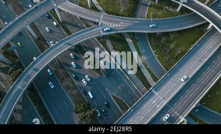 Top up aerial drone view of elevated road and traffic junctions in Chinese metropolis city Chengdu during sunny day. Modern roads construction Stock Photo