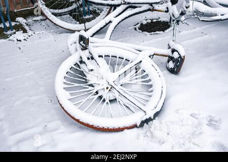 Wheel of a bicycle covered with fresh snow Stock Photo