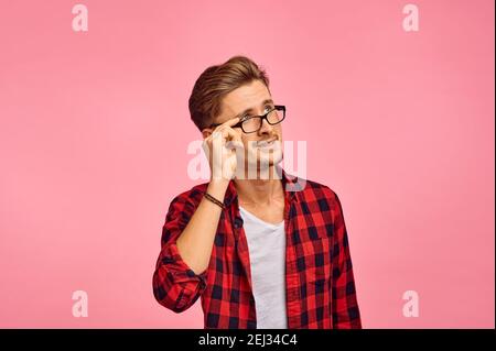 Serious man in glasses, pink background, emotion Stock Photo