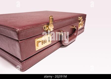 Closed 24 hour briefcase with open lock on white background Stock Photo