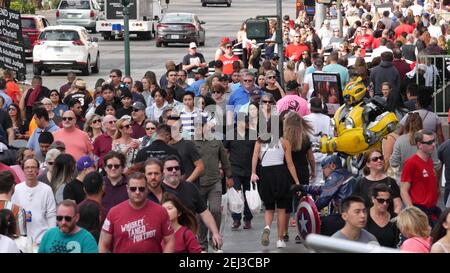 LAS VEGAS, NEVADA USA - 7 MAR 2020: People on pedestrian walkway. Multicultural men and women walking on city promenade. Crowd of citizens on sidewalk Stock Photo