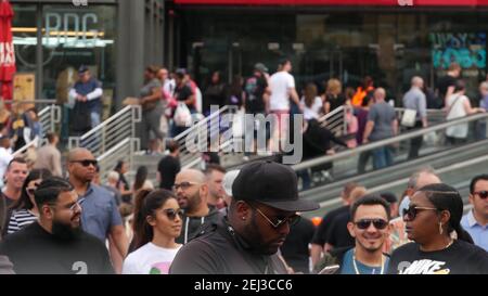 LAS VEGAS, NEVADA USA - 7 MAR 2020: People on pedestrian walkway. Multicultural men and women walking on city promenade. Crowd of citizens on sidewalk Stock Photo