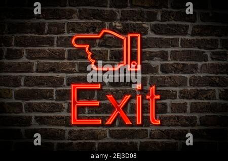 Detail photo of a neon sign on a wall with the inscription Exit Stock Photo