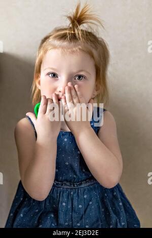 Little girl in the doctor's office at the clinic. Sitting waiting for a pediatrician examination before vaccination. Afraid. Concept of vaccination, i Stock Photo