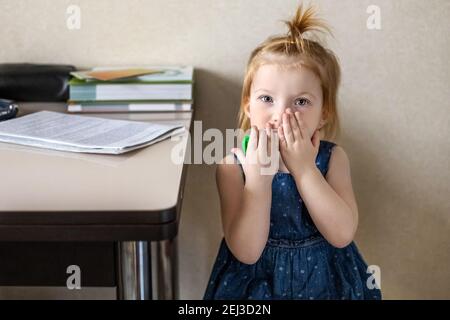 Little girl in the doctor's office at the clinic. Sitting waiting for a pediatrician examination before vaccination. Afraid. Concept of vaccination, i Stock Photo