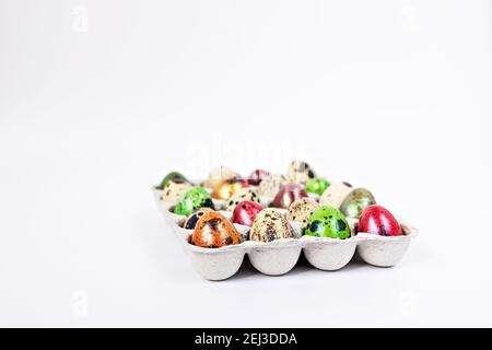 Colored quail Easter eggs in a box on the white background. Easter holiday concept. Stock Photo