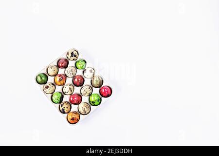 Colored quail Easter eggs in a box on the white background. Easter holiday concept. Stock Photo