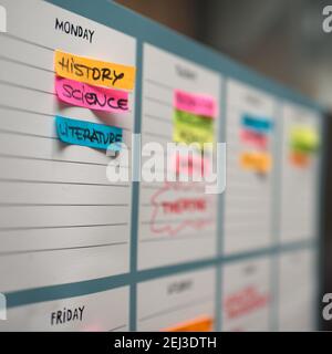 Weekly scholar timetable with colorful handwritten sticky notes. On Monday History, Science and Literature Stock Photo