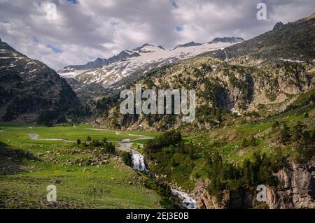 Plan and Forau d'Aigualluts (meadow and waterfall) under the Aneto summit in summer (Benasque, Pyrenees, Spain) Stock Photo