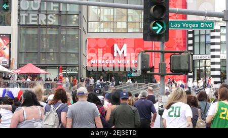 LAS VEGAS, NEVADA USA - 7 MAR 2020: People on pedestrian walkway. Multicultural men and women walking on city promenade. Crowd of citizens on sidewalk Stock Photo