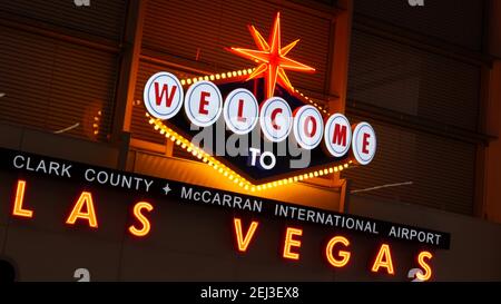 LAS VEGAS, NEVADA USA - 9 MAR 2020: Welcome to fabulous Sin City illuminated retro neon sign inside McCarran airport. Iconic greeting vintage styled s Stock Photo