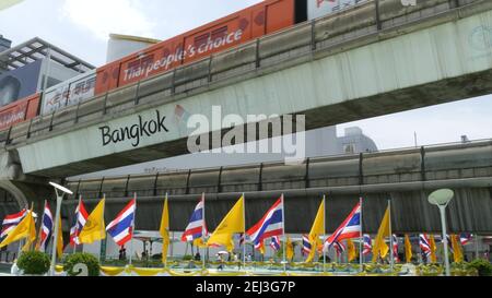 BANGKOK, THAILAND - 11 JULY, 2019: Pedestrians walking on the bridge near MBK and Siam Square under BTS train line. People in festive modern city deco Stock Photo