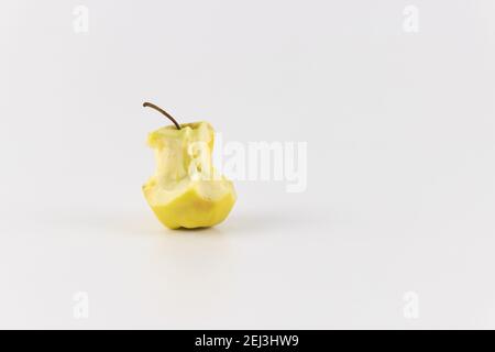 Golden green delicious bitten apple isolated on white. An apple stub. Stock Photo
