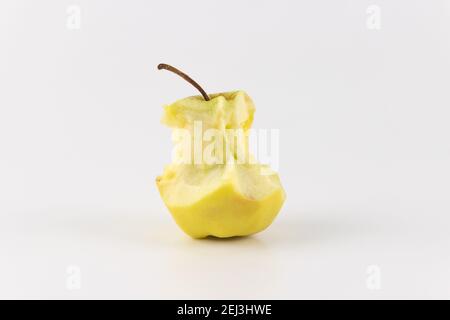 Golden green delicious bitten apple isolated on white. An apple stub. Stock Photo