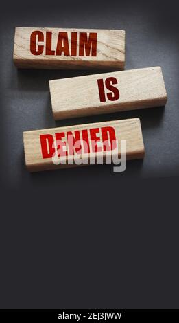 Claim is denied on Wooden Blocks on dark grey background with copyspace. The answer is No. Business financing sponsorship concept. Stock Photo