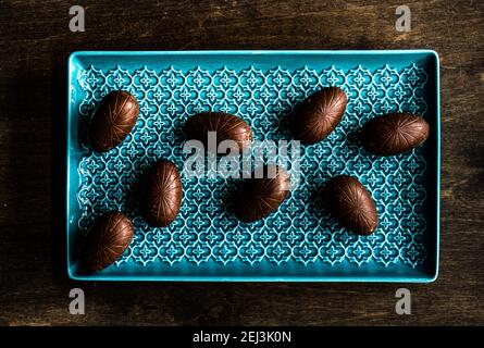Easter place setting with various chocolate eggs in a bowl Stock Photo