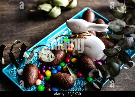 Easter place setting with various chocolate eggs in a bowl Stock Photo