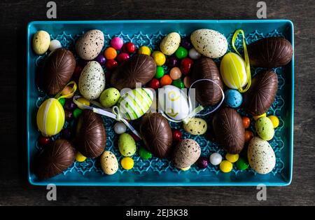 Easter place setting with various chocolate eggs in a bowl Stock Photo