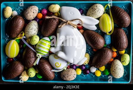 Easter place setting with various chocolate eggs in a bowl Stock Photo