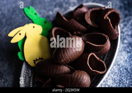 Easter place setting with various chocolate eggs in a bowl Stock Photo