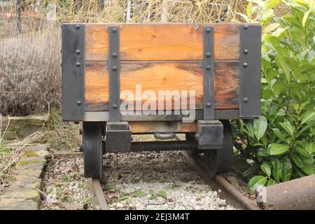 Short wheelbase coal tub on metal tracks, coal mining industrial past concept image 1 in a series of 5 Stock Photo