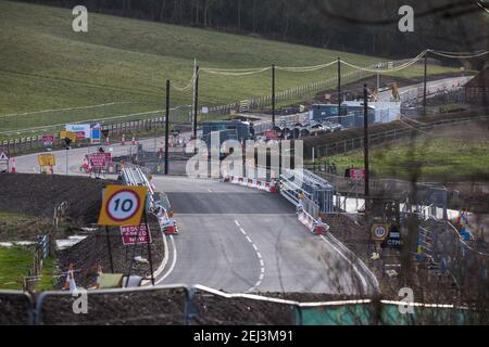 Chalfont St Giles, UK. 20th February, 2021. A raised temporary haul road is being prepared alongside Bottom House Farm Lane for use in the construction of a ventilation shaft for the Chiltern Tunnel on the HS2 high-speed rail link. Credit: Mark Kerrison/Alamy Live News Stock Photo