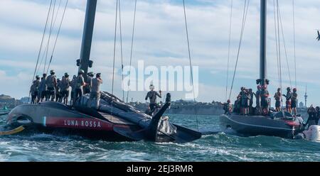 Auckland, New Zealand, 21 February, 2021 -  Sailing teams from Luna Rossa Prada Pirelli and  INEOS Team UK's Britannia applaud each other at the end of the Prada Cup Final on Auckland's Waitemata Harbour. Luna Rossa won the contest 7-1 and will challenge Emirates Team New Zealand in the 36th America;s Cup starting on March 6. Credit: Rob Taggart/Alamy Live News Stock Photo