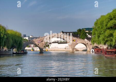 The landmark wulong qiao or five dragon bridge over the grand canal in the city of suzhou china on a sunny day in jiangsu province. Stock Photo