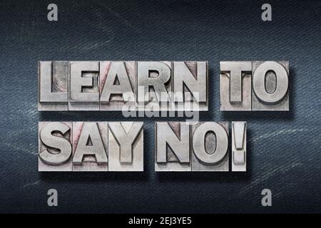 learn to say no phrase made from metallic letterpress on dark jeans background Stock Photo