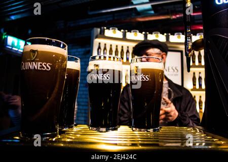 Pints of Guinness in the museum in Dublin. Guinness is an Irish dry stout produced by Diageo originated in the brewery of Arthur Guinness Stock Photo