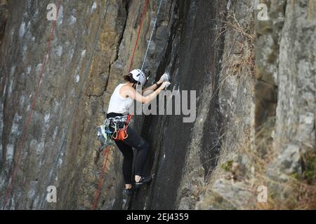 Asian girl rock climbing Stock Photo - Alamy